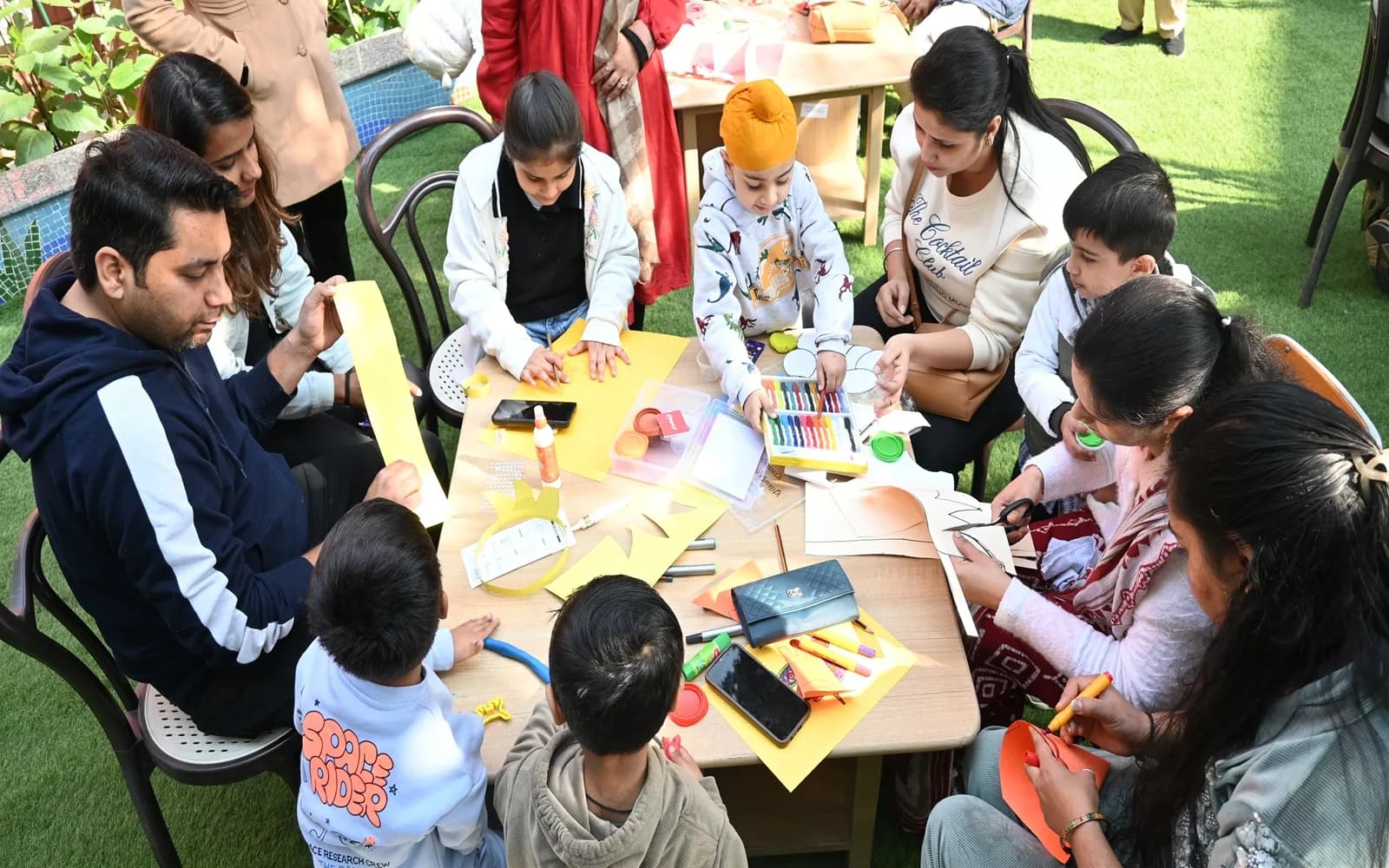 Families and students creating artwork together at a school community event